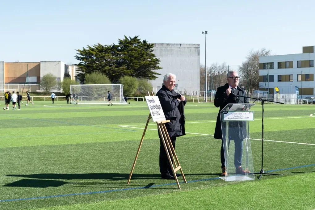 Deux hommes sur un terrain de foot.