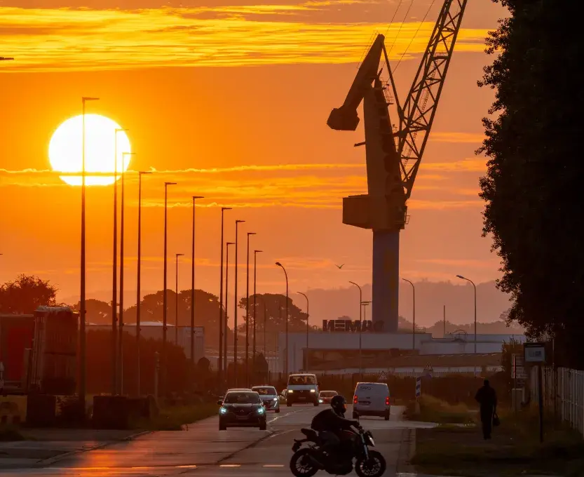 coucher de soleil sur la rade avec l'ombre d'une grue