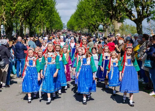 Des jeunes filles défilant en cortège dans les costumes bretons de Plougastel